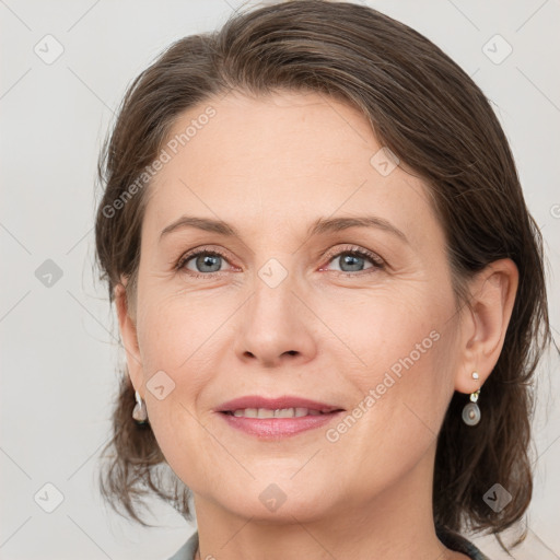 Joyful white adult female with medium  brown hair and grey eyes