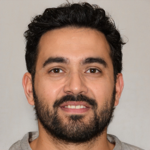 Joyful latino young-adult male with short  black hair and brown eyes