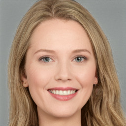 Joyful white young-adult female with long  brown hair and green eyes