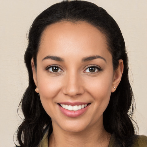 Joyful white young-adult female with long  black hair and brown eyes