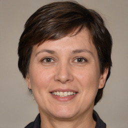 Joyful white adult female with medium  brown hair and brown eyes