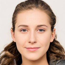 Joyful white young-adult female with long  brown hair and blue eyes