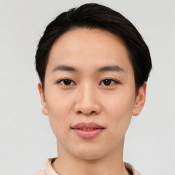 Joyful asian young-adult female with short  black hair and brown eyes