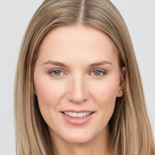 Joyful white young-adult female with long  brown hair and grey eyes