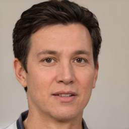 Joyful white adult male with short  brown hair and brown eyes