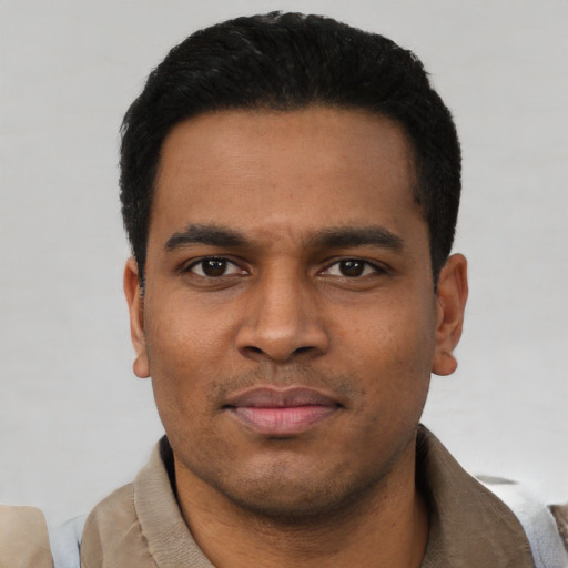 Joyful latino young-adult male with short  black hair and brown eyes