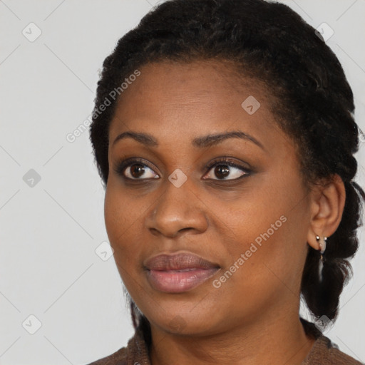 Joyful black young-adult female with long  black hair and brown eyes