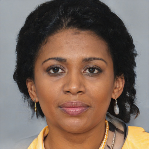 Joyful black young-adult female with medium  brown hair and brown eyes