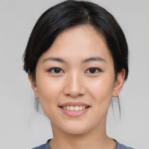 Joyful asian young-adult female with medium  black hair and brown eyes