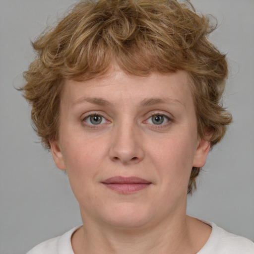 Joyful white young-adult female with medium  brown hair and blue eyes