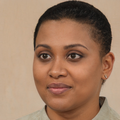 Joyful black young-adult female with short  brown hair and brown eyes