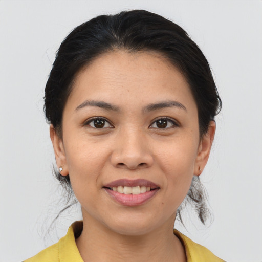 Joyful asian young-adult female with medium  brown hair and brown eyes