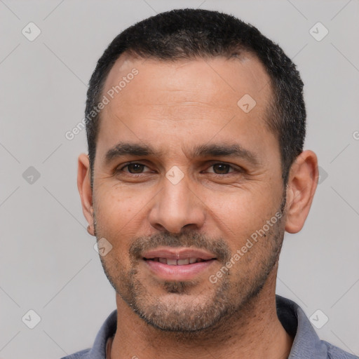 Joyful white young-adult male with short  black hair and brown eyes