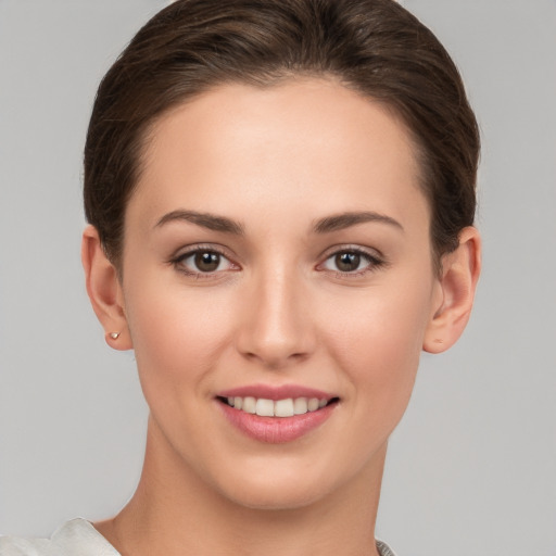 Joyful white young-adult female with short  brown hair and brown eyes