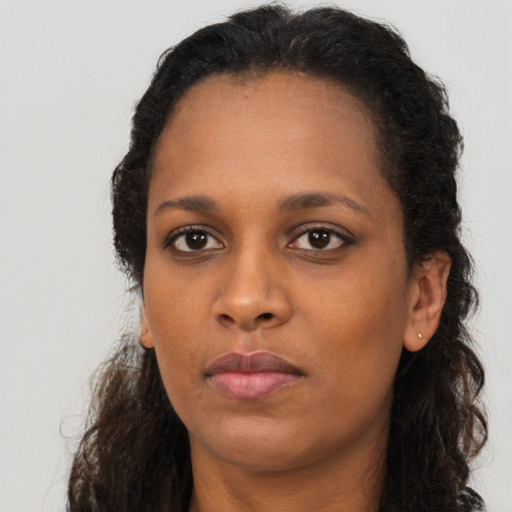Neutral black young-adult female with long  brown hair and brown eyes