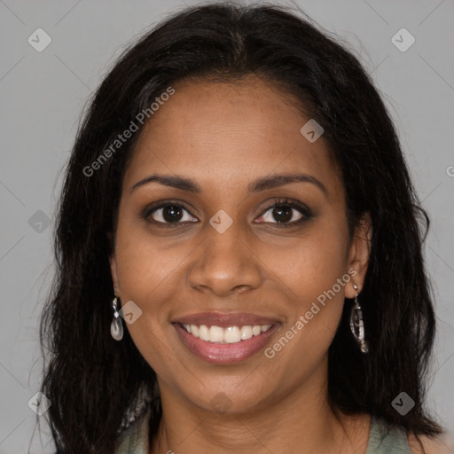 Joyful black young-adult female with long  brown hair and brown eyes