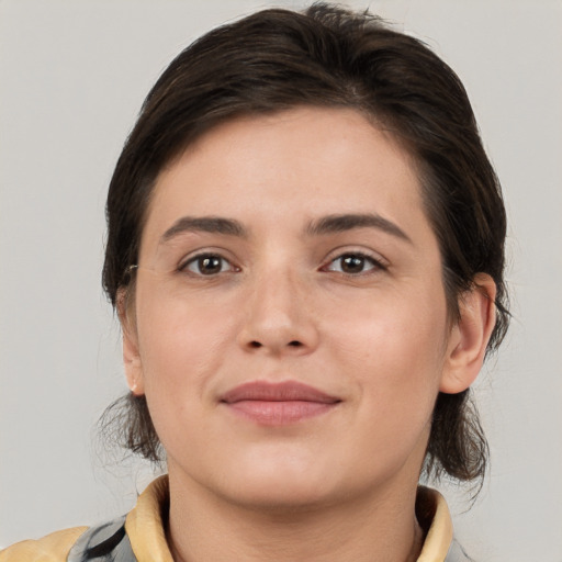 Joyful white young-adult female with medium  brown hair and brown eyes