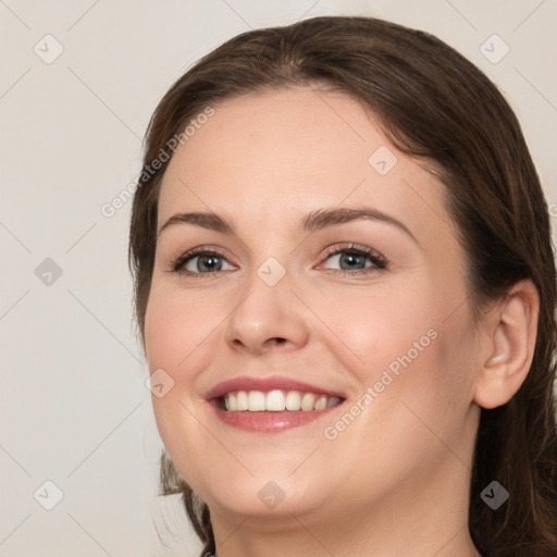 Joyful white young-adult female with medium  brown hair and grey eyes