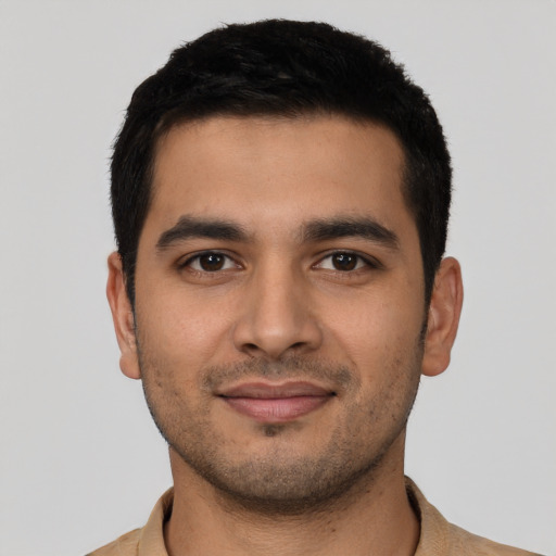 Joyful latino young-adult male with short  black hair and brown eyes