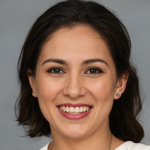 Joyful white young-adult female with medium  brown hair and brown eyes