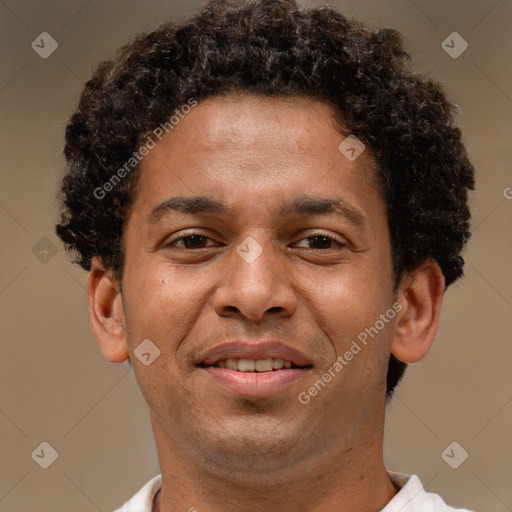 Joyful black adult male with short  brown hair and brown eyes