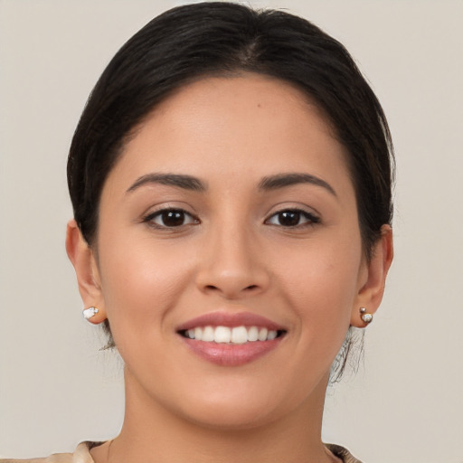 Joyful white young-adult female with long  brown hair and brown eyes