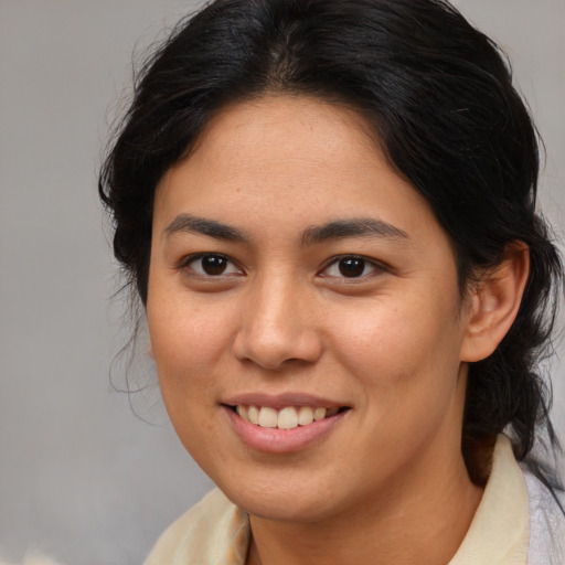 Joyful latino young-adult female with medium  brown hair and brown eyes