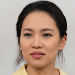 Joyful asian young-adult female with medium  brown hair and brown eyes