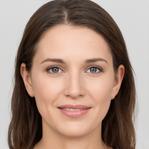 Joyful white young-adult female with long  brown hair and grey eyes