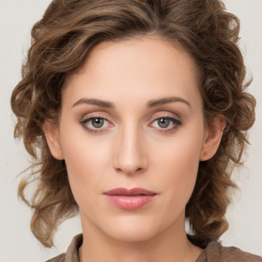 Joyful white young-adult female with medium  brown hair and green eyes