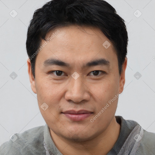 Joyful asian young-adult male with short  black hair and brown eyes