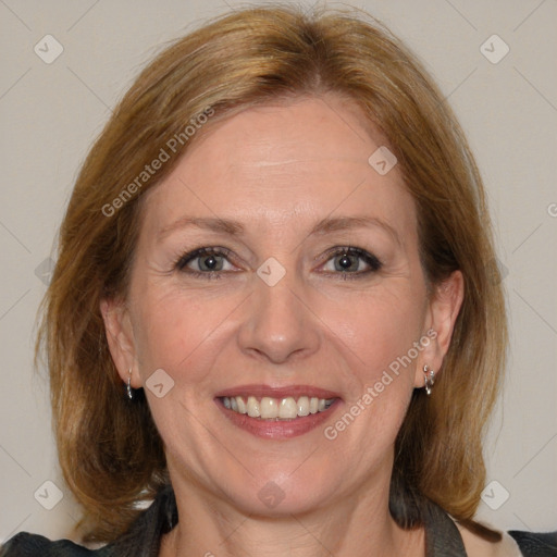 Joyful white adult female with medium  brown hair and blue eyes