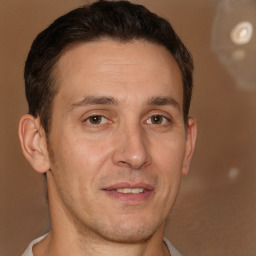 Joyful white adult male with short  brown hair and brown eyes