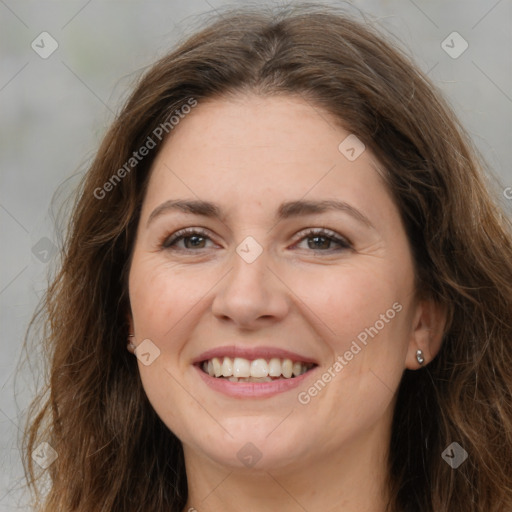 Joyful white adult female with long  brown hair and brown eyes