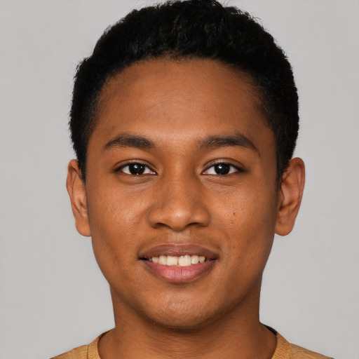 Joyful black young-adult male with short  brown hair and brown eyes