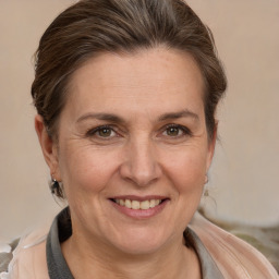 Joyful white adult female with medium  brown hair and brown eyes