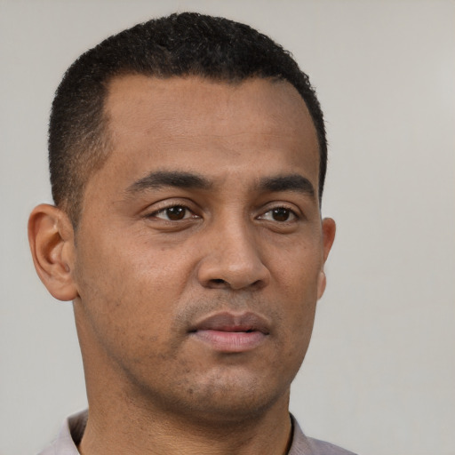 Neutral latino young-adult male with short  brown hair and brown eyes