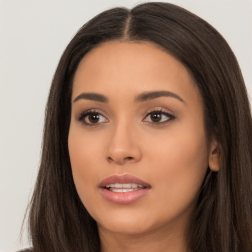 Joyful latino young-adult female with long  brown hair and brown eyes