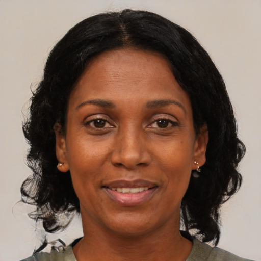 Joyful black adult female with medium  black hair and brown eyes