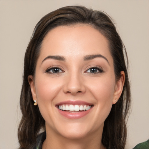 Joyful white young-adult female with medium  brown hair and brown eyes