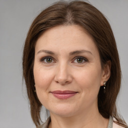 Joyful white adult female with medium  brown hair and grey eyes