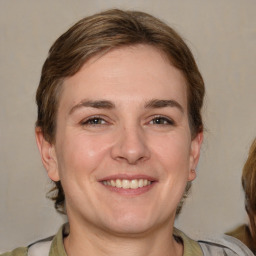 Joyful white young-adult female with medium  brown hair and brown eyes