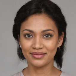 Joyful black young-adult female with medium  brown hair and brown eyes