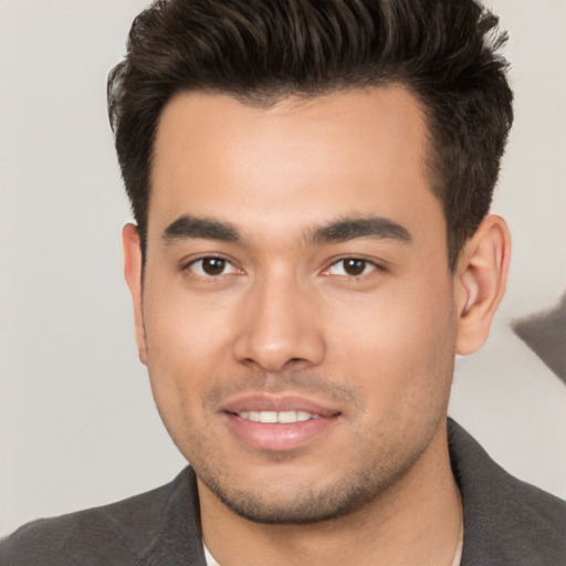 Joyful white young-adult male with short  black hair and brown eyes