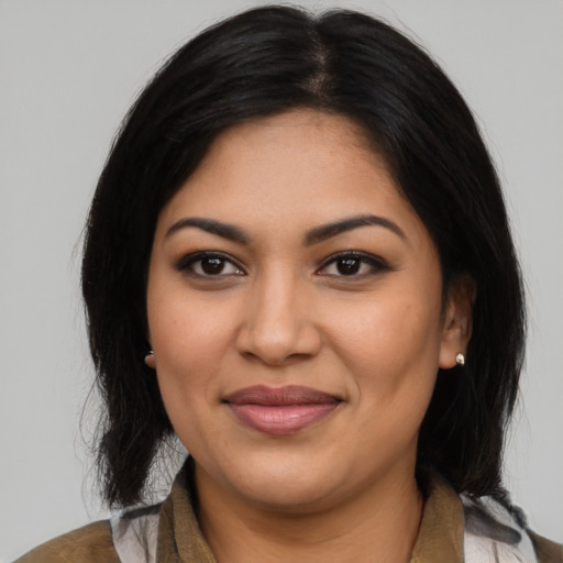 Joyful latino young-adult female with medium  black hair and brown eyes