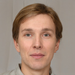 Joyful white adult male with short  brown hair and grey eyes