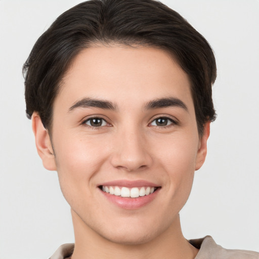 Joyful white young-adult female with short  brown hair and brown eyes