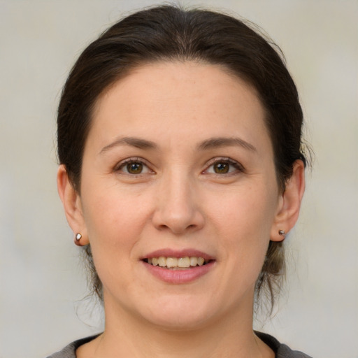 Joyful white young-adult female with medium  brown hair and brown eyes