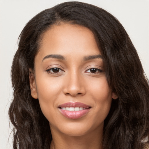 Joyful latino young-adult female with long  brown hair and brown eyes