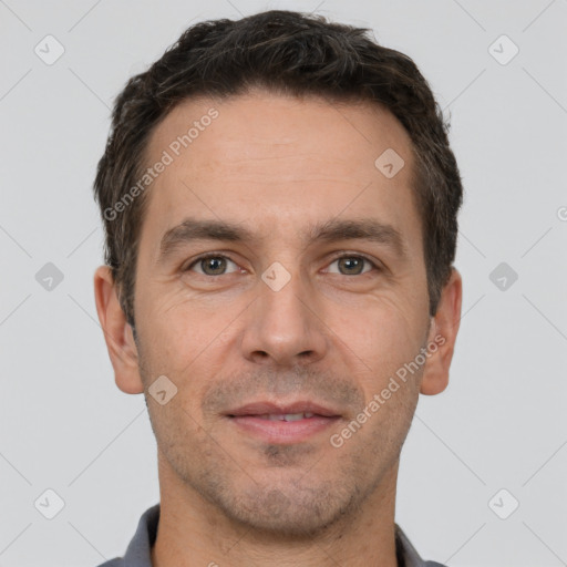 Joyful white adult male with short  brown hair and brown eyes